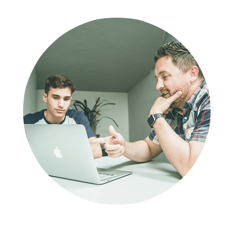 Image of men looking at a laptop