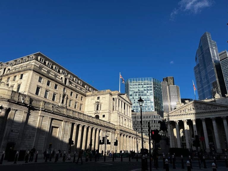 Modern and historic buildings under a clear blue sky.