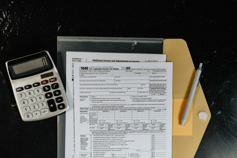 Calculator and tax forms on a dark surface