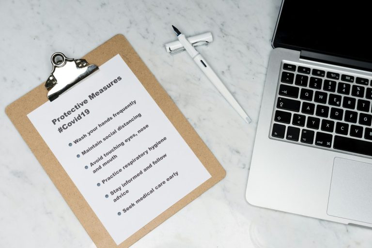 white and brown card on silver macbook
