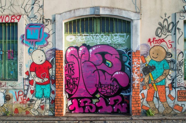 purple and blue graffiti on wall