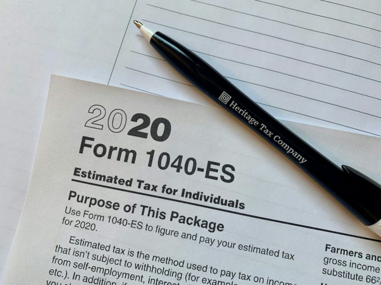 A pen sitting on top of a tax form