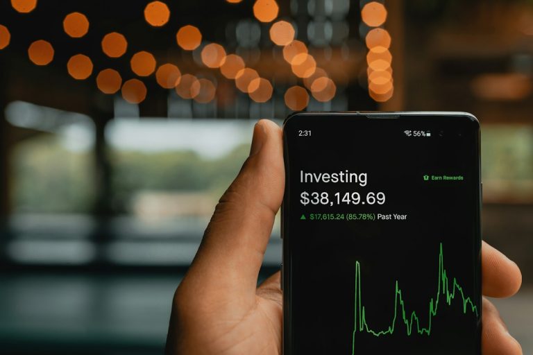 A person analysing financial and market charts on a screen