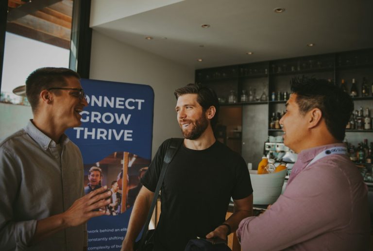 A group of three business professionals discussing startup growth