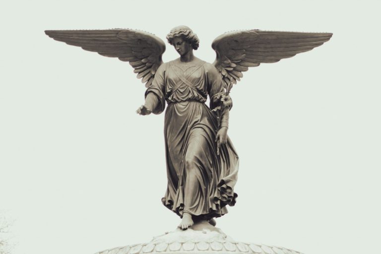 A classical stone angel statue representing early investment support
