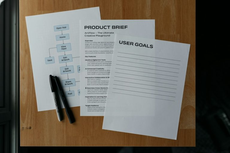 Documents and a pen lay on a wooden surface