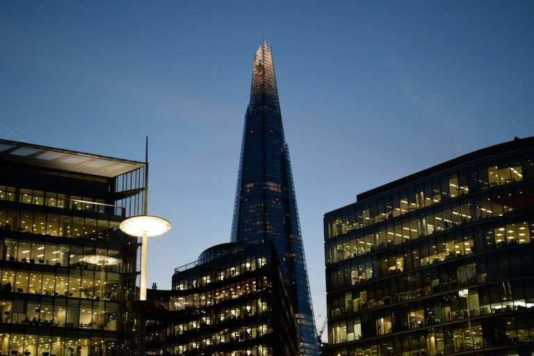 The Shard towers above other London buildings at dusk