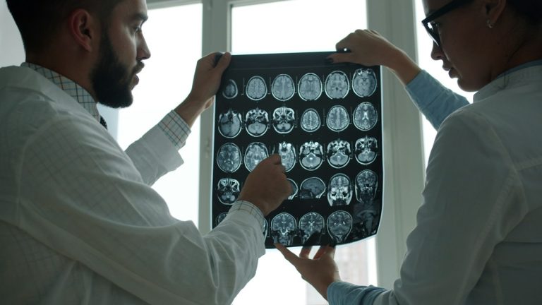 Two doctors examining a brain mri scan together