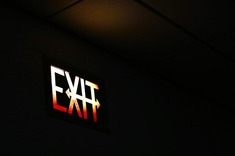 Illuminated exit sign in dark room