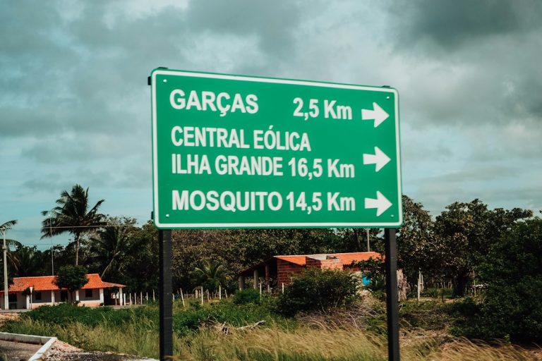 Green directional sign with distances to locations